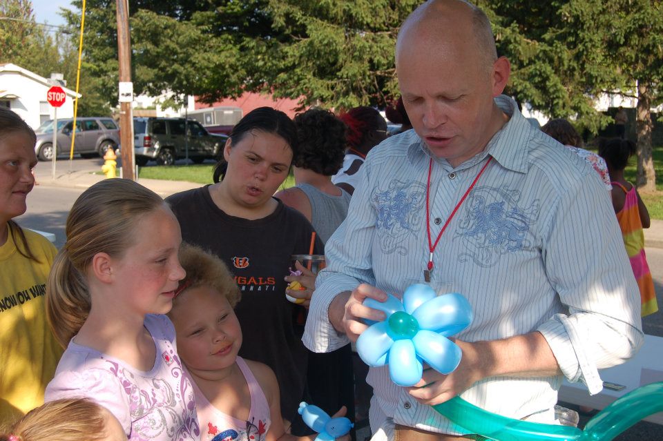 Brad Brown making balloon sculptures for kids