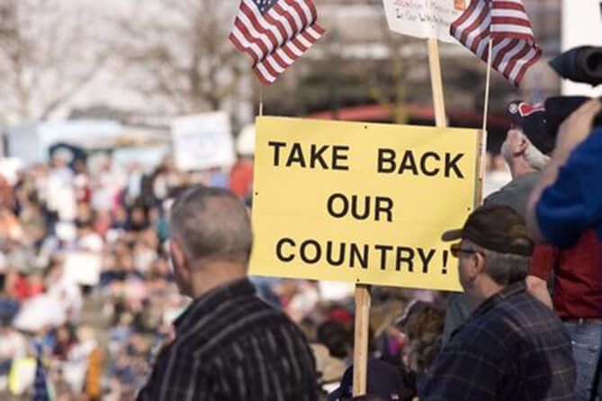 Protestors with Take Back Our Country sign